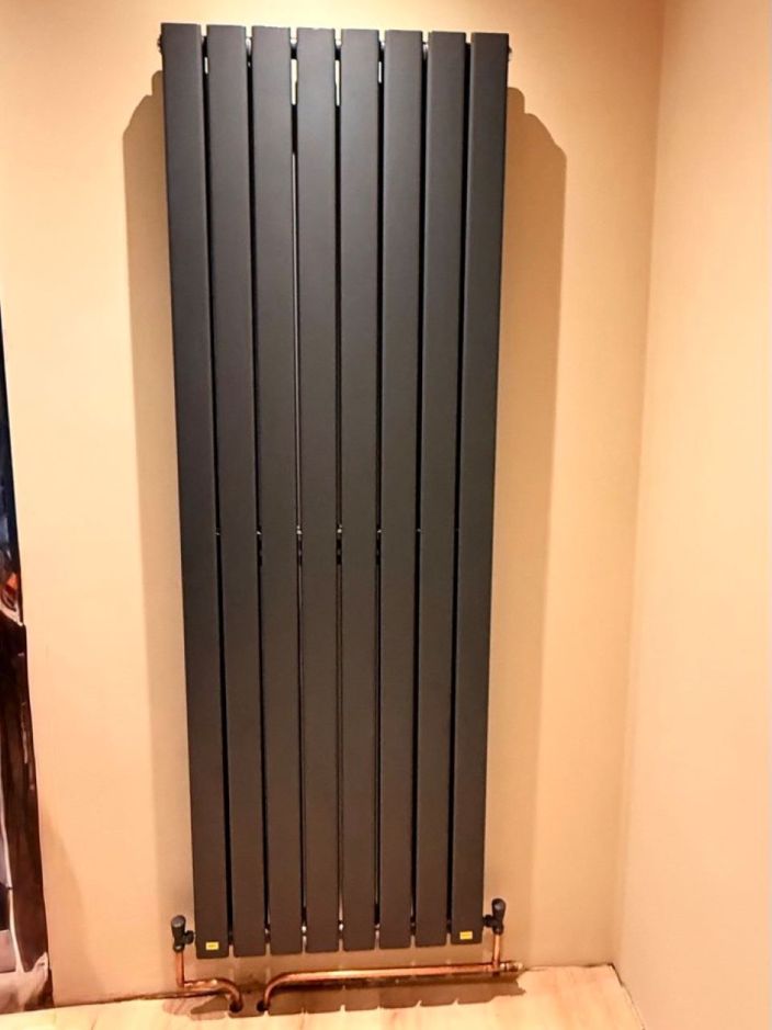 Vertical radiator replacement by plumber in Essex